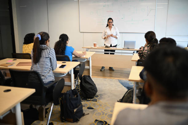 istock Female Instructor teaching mature adult students in the classroom 1429679154