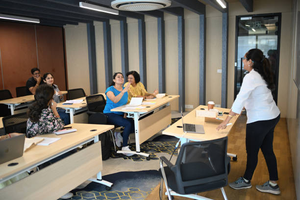 istock Female Instructor teaching mature adult students in the classroom 1429679301