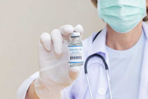 Close Up on  Caucasian Female Doctor Hold Covid19 Vaccine Bottle