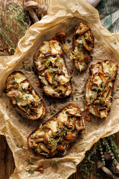 istock Sourdough bread toasts with forest mushrooms, mozzarella cheese and thyme, top view 1429683388