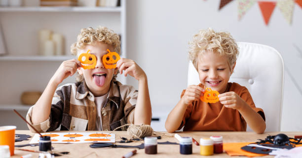istock Cute children  boys making Halloween home decorations 1429684794
