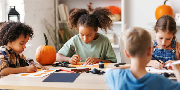 istock Happy multinational group of children making Halloween home decorations together 1429685725