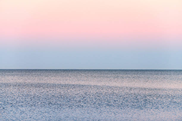 istock Atmospheric romantic pink red sea sunset sky above blue quiet water, minimalistic peaceful seascape 1429686478