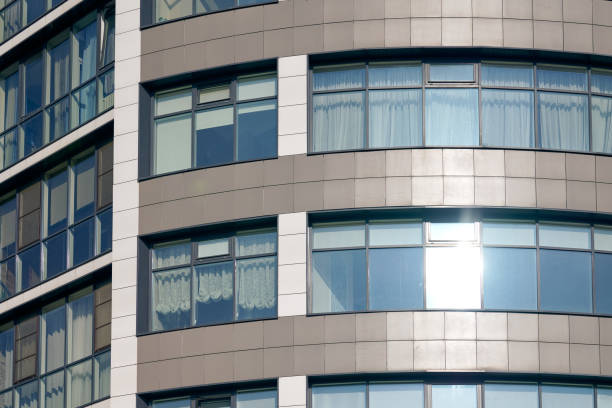 istock Close up view to office skyscraper windows, high business building windows with sunlight glare 1429686514