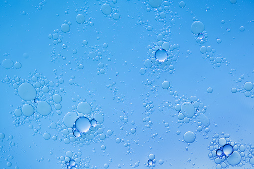 Multiple tiny water droplets on a turquoise surface