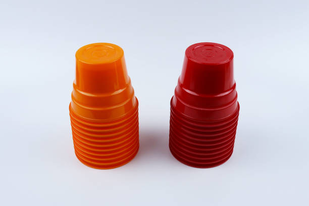 istock Stacks of orange and red plastic cups isolated on white background 1429691347