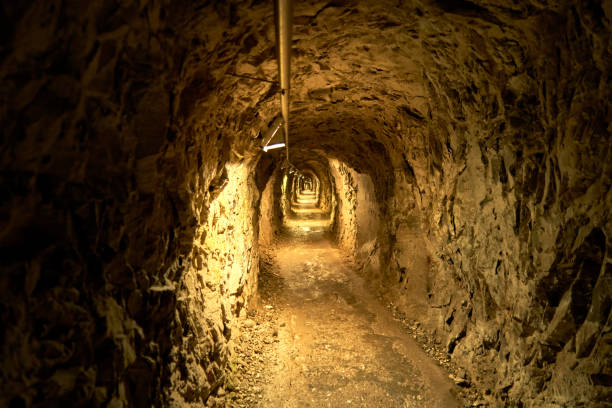 istock Narrow tunnel with raw rock walls underground 1429693359