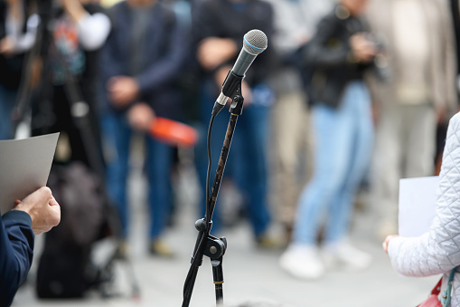 Microphone at a public event, unrecognizable people in background