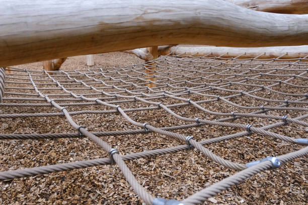 A cargo net stretched out between trees. Focus is on centre of net.
