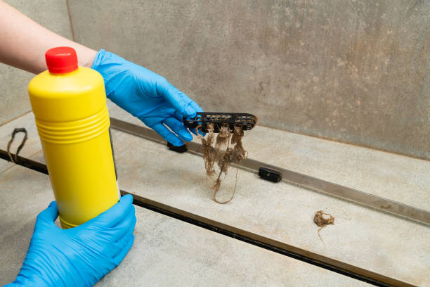istock Woman using liquid drain cleaners to clean bathroom sink drain. 1429696367