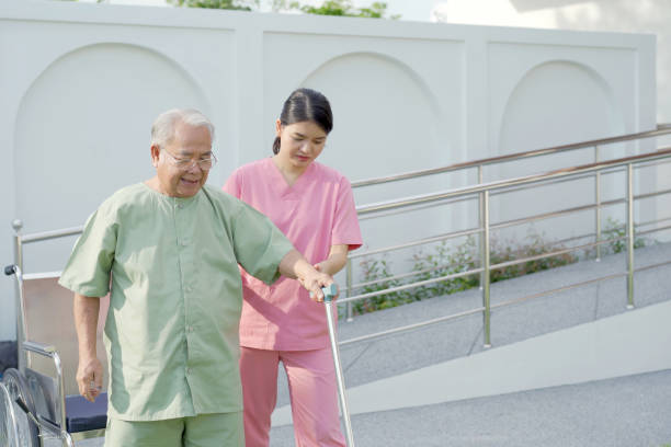 istock Nurse or caregiver taking elder old man to exercise. 1429697293