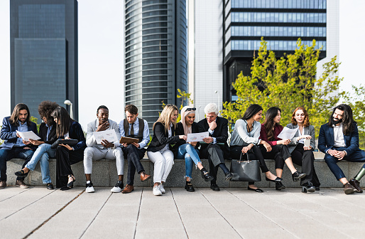 Panoramic view of business people having a briefing outside the office