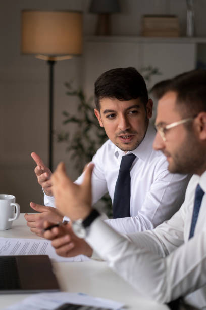 istock Two young businessmen discuss or plan project in office 1429698995