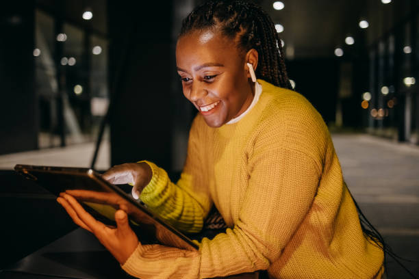 istock Woman uses a tablet in a dark street 1429708754