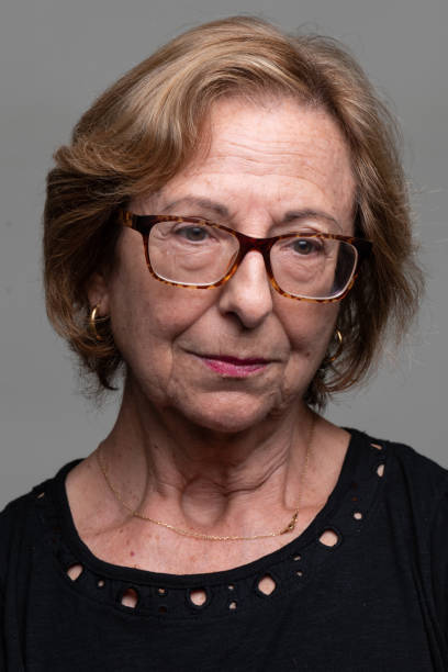 istock Sad, Serious Senior Woman looking down front mugshot 1429709098