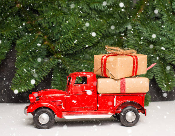 istock Christmas red car or truck carrying gift boxes. 1429710928