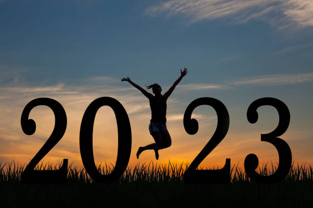 Silhouette young woman happy for 2023 new year stock photo