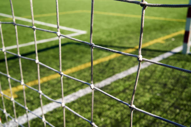 istock String net at a football playground, with green grass behind 1429716248