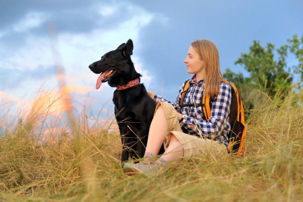 istock Woman with her dog against sky background 1429721307