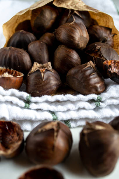 istock A handful of roasted chestnuts in a paper envelope on a kitchen towel 1429721897