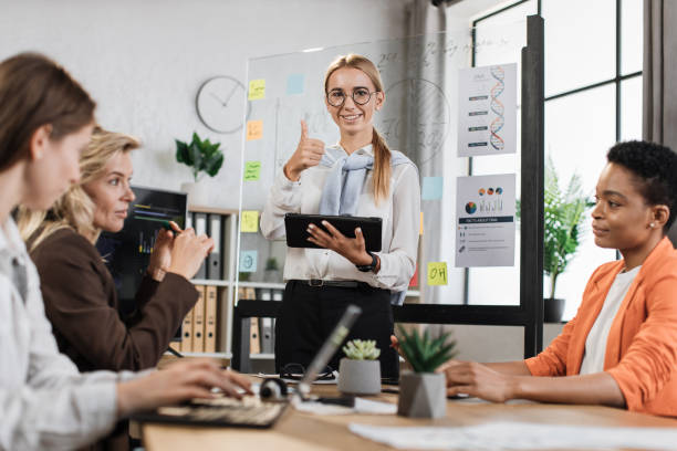 istock Caucasian blond woman with tablet in hands looking at camera while standing at office. 1429726745