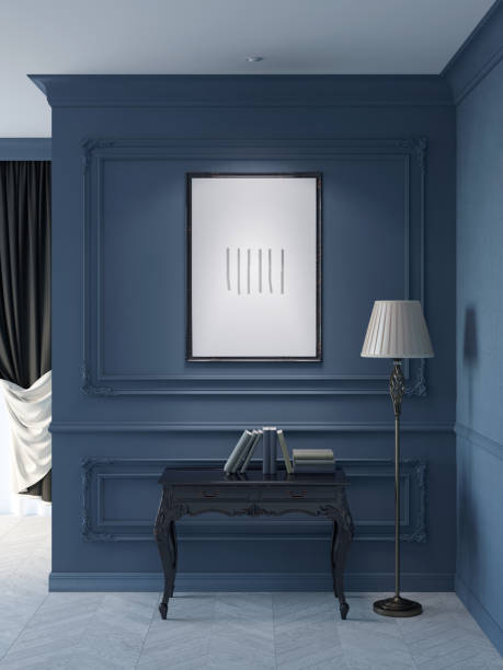 istock Classic room with an illuminated vertical poster on the dark blue wall with moldings, a floor lamp near a black wooden console with books, and a window with black curtains in the background. 1429729539