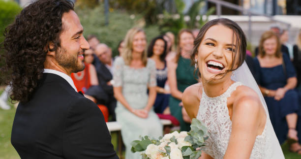 istock Happy married couple during marriage ceremony or reception celebration outdoors. Bride and groom make a love commitment to become husband and wife together in a healthy and romance relationship 1429730722