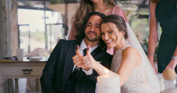 istock Thumbs up happy wedding couple smile after commitment marriage certificate signature event and jewelry celebration. Love, happiness and joyful bride and groom at ring ceremony with friends or family 1429730831