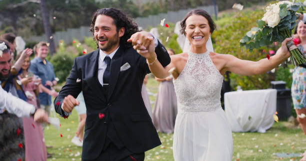 istock Wedding, confetti and happy couple celebrate commitment day. Respect, trust and love in romantic relationship with special person. Marriage event with bride and groom holding hands in aisle. 1429730846