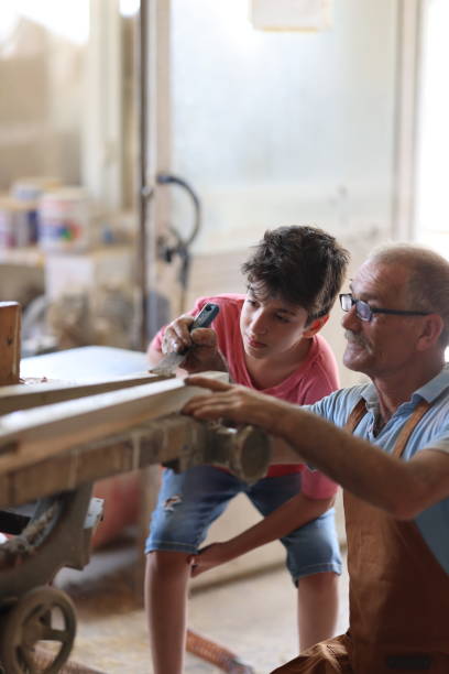 istock Grandfather and grandson in workshop 1429733538