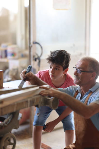 istock Grandfather and grandson in workshop 1429733714