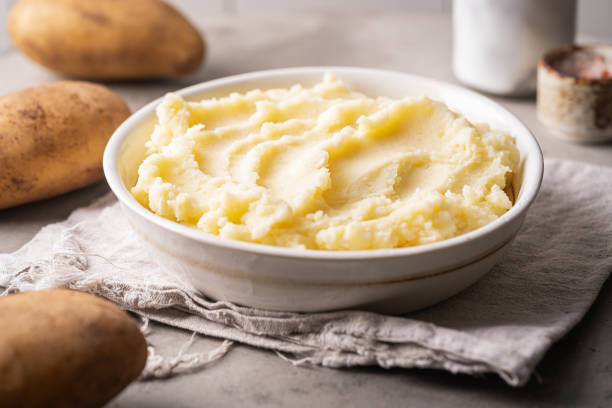 Mashed potatoes in bowl Mashed potatoes in white bowl on grey concrete background. Healthy food mashed potatoes stock pictures, royalty-free photos & images