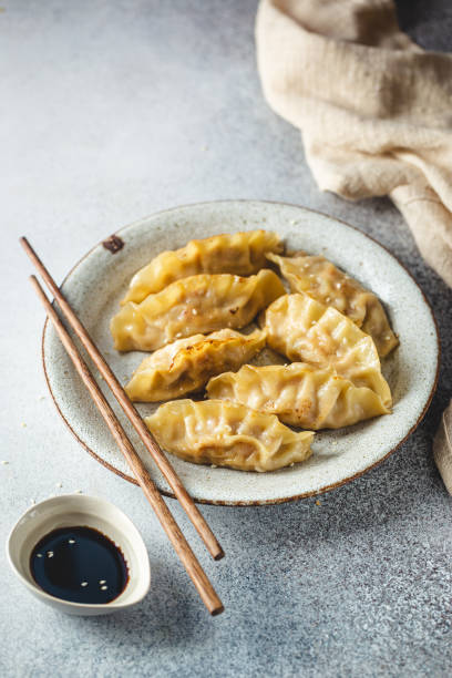 istock Asian dumplings with soy sauce 1429744347