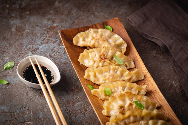 istock Asian dumplings with soy sauce 1429744355