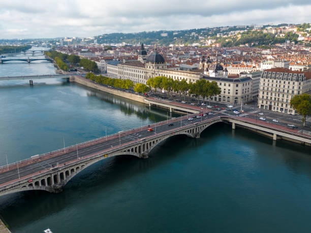 Aerial view of Pont Wilson bridge over River Rhone in Lyon Aerial drone view of the River Rhone in the French city of Lyon, looking down at the Pont Wilson bridge. The view looks across to the historic part of the city on the north bank, which is on a peninsula of land with the Rhone on the south side and the River Saone on the north side of the peninsula. The area is part of a UNESCO World Heritage site. auvergne rhône alpes stock pictures, royalty-free photos & images