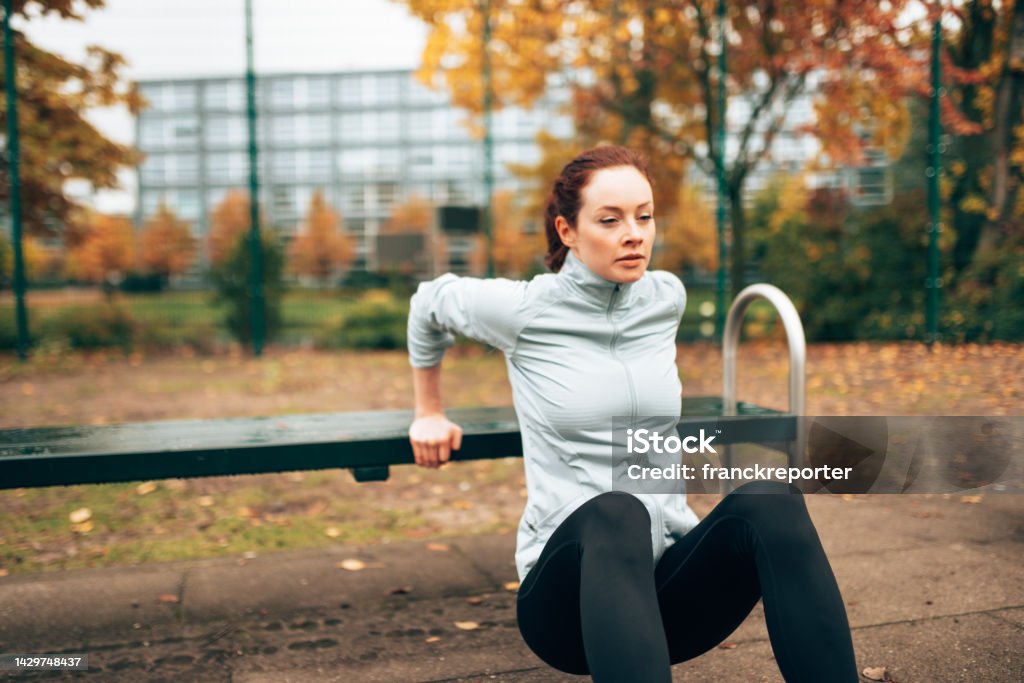 sportive woman doing pushups on the park Active Lifestyle Stock Photo