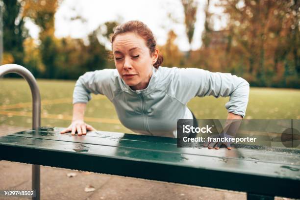 Sportive Woman Doing Pushups On The Park Stock Photo - Download Image Now - 20-24 Years, Active Lifestyle, Adult