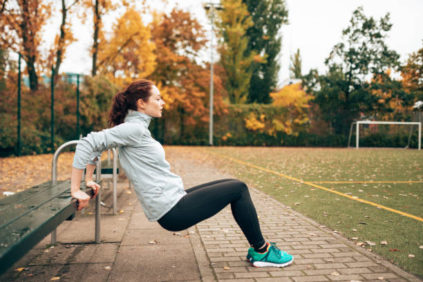 istock sportive woman doing pushups on the park 1429748620
