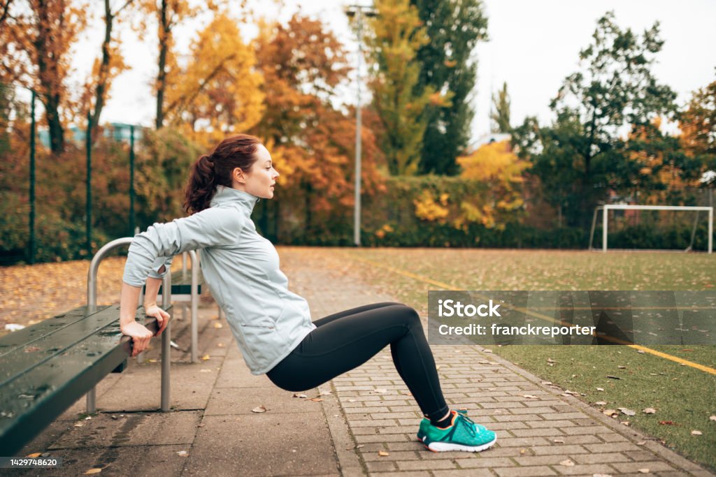 sportive woman doing pushups on the park Active Lifestyle Stock Photo