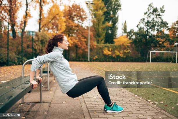 Sportive Woman Doing Pushups On The Park Stock Photo - Download Image Now - Active Lifestyle, Adult, Adults Only