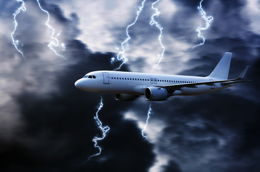 Airplane in the sky with thunder and lightning,The plane flies in terrible thunderstorm,Concept of climate weather