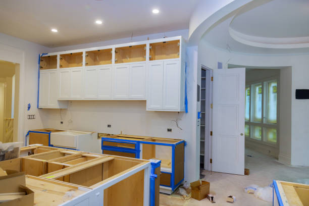 In a newly constructed house, the installation of white cabinets in the kitchen was completed stock photo