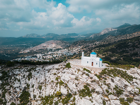 Greek church, with white facade and blue dome on a mountain in Greece mainland.