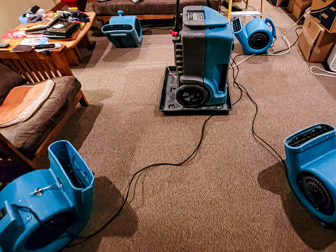 Water damaged home being dried out with air movers and a dehumidifier