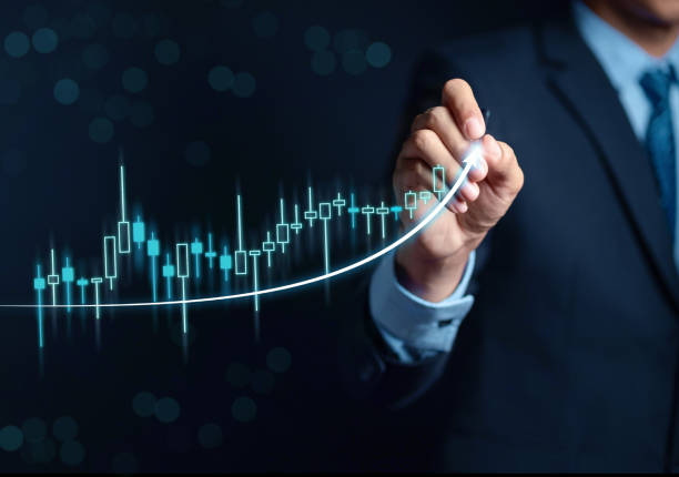 istock Businessman writing target analyze sales data trading and showing a growing virtual screen of statistics, graph and chart with arrow up. Stock market business growth, planing and strategy concept. 1429813278