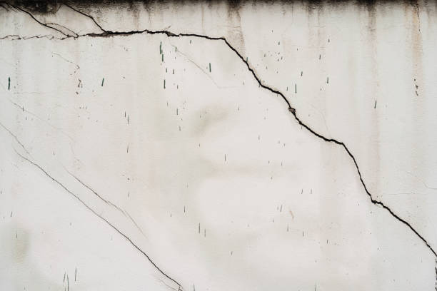 istock house broken. concrete crack. Water damage building interior. large crack white concrete wall 1429816372
