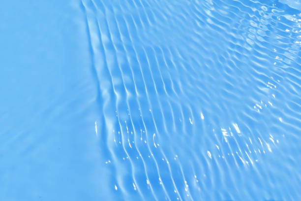 istock Defocus blurred transparent blue colored clear calm water surface texture with splash, bubble. Shining blue water ripple background. Surface of water in swimming pool. Blue bubble water shining. 1429828561