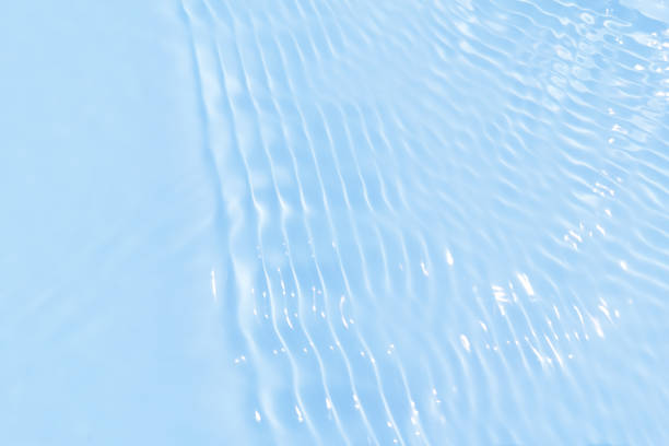 istock Defocus blurred transparent blue colored clear calm water surface texture with splash, bubble. Shining blue water ripple background. Surface of water in swimming pool. Blue bubble water shining. 1429828723