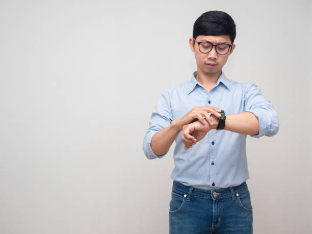 istock Young businessman busy looking at his watch copy space 1429832815