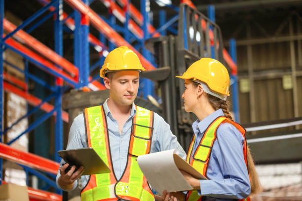 istock Manager and supervisor taking inventory in warehouse, Female foreperson making plans with warehousemen, Workers working in warehouse 1429835079